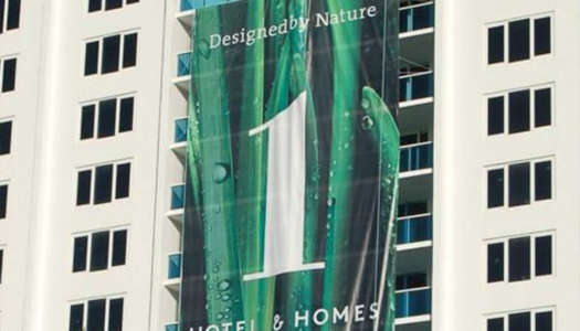 A banner advertising a hotels #1 ranking on the side of a building